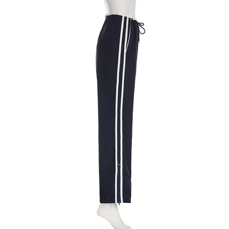 Navy blue athletic pants with white double stripes and drawstring waist on mannequin