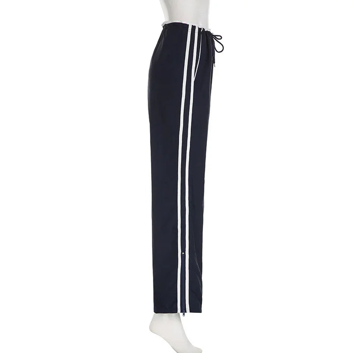 Navy blue athletic pants with white double stripes and drawstring waist on mannequin