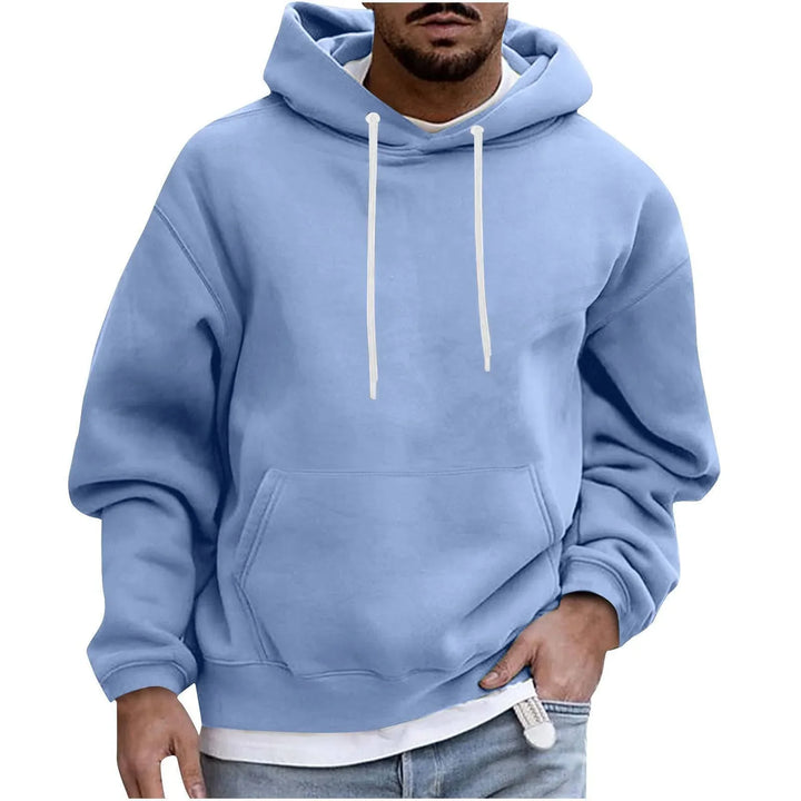 Man wearing light blue hoodie with white drawstrings and front pocket, casual streetwear style