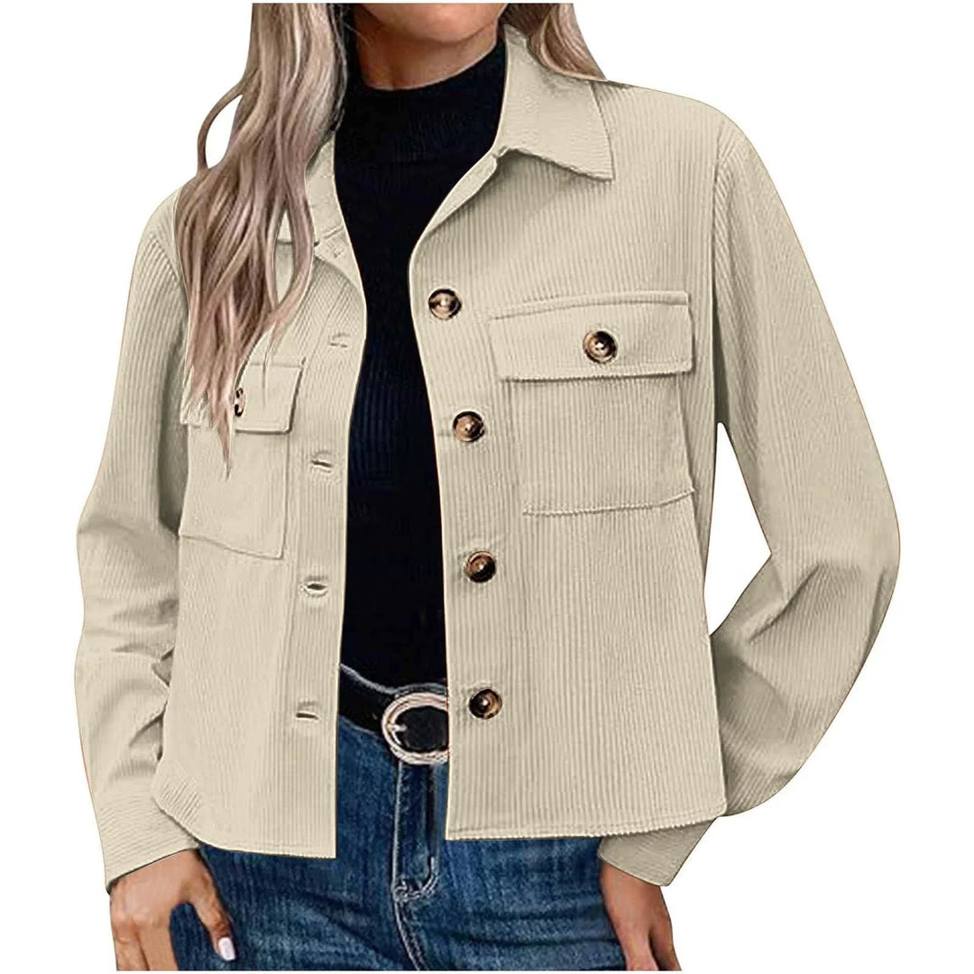Woman wearing beige corduroy button-up jacket with flap pockets over black top and blue jeans