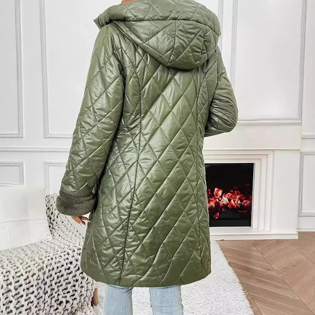 Back view of olive green quilted puffer coat with hood and fur cuffs worn indoors