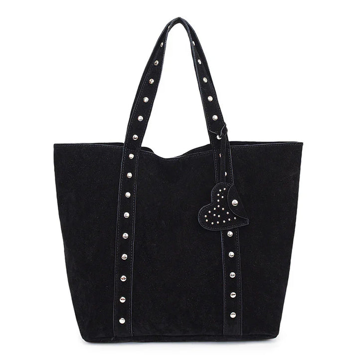 Black suede tote bag with silver studs on straps and heart-shaped studded charm