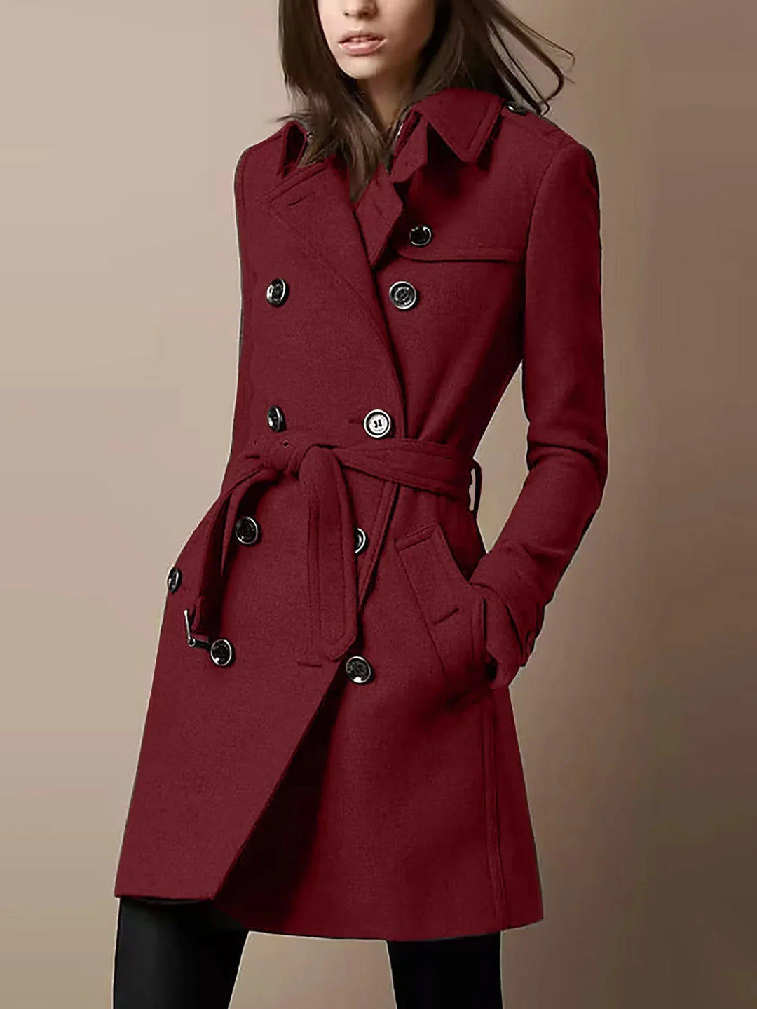 Woman wearing double-breasted burgundy wool trench coat with belt and black buttons