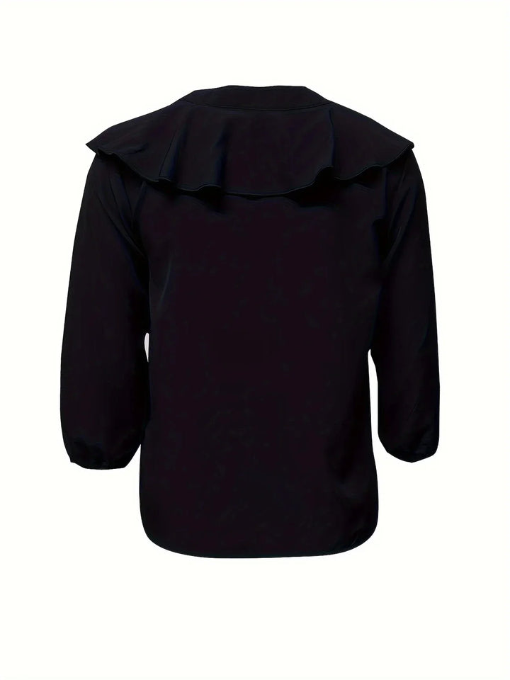 Back view of black blouse with ruffled yoke detail and three-quarter sleeves