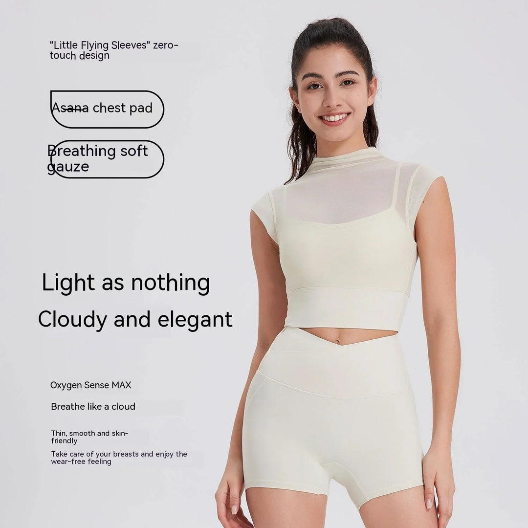 Smiling woman in white breathable mesh crop top and high-waisted shorts fit for exercise