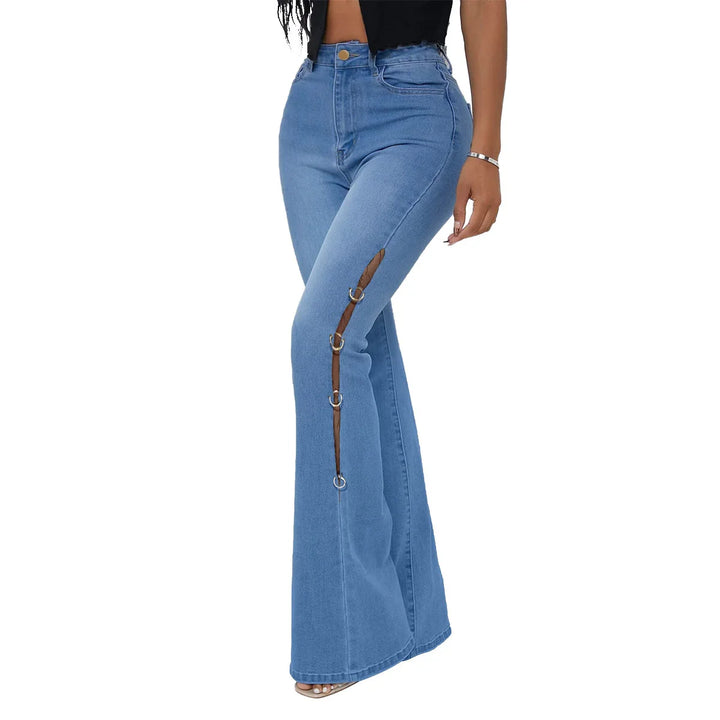 Woman wearing high-waisted blue denim flare jeans with side cutouts and metal ring details