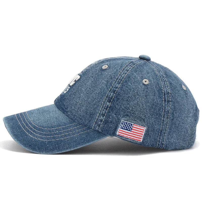 Blue denim baseball cap with embroidered American flag patch on side and white stitching