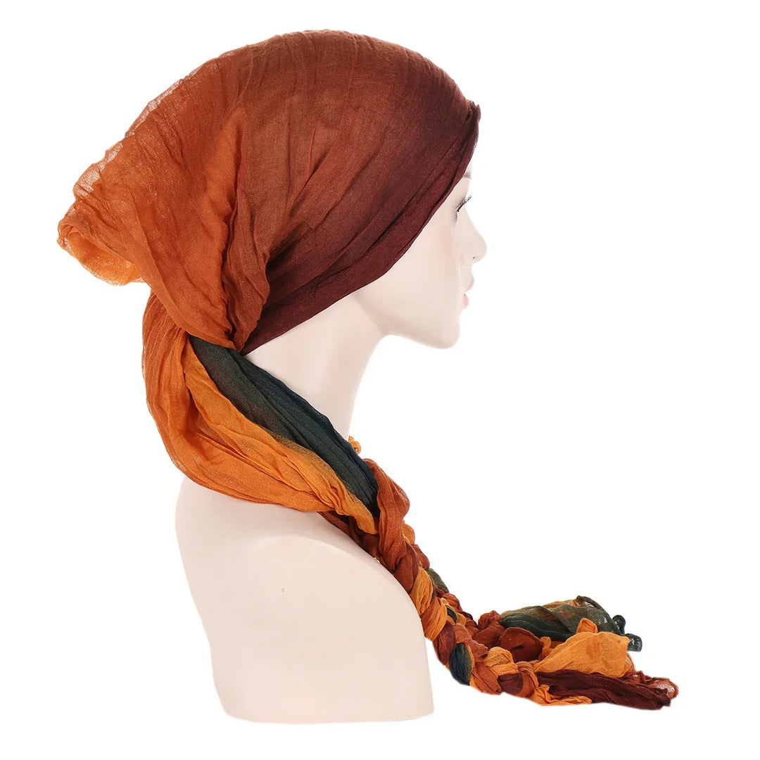 Side view of mannequin wearing multicolored lightweight braided scarf headwrap in brown, orange, and green