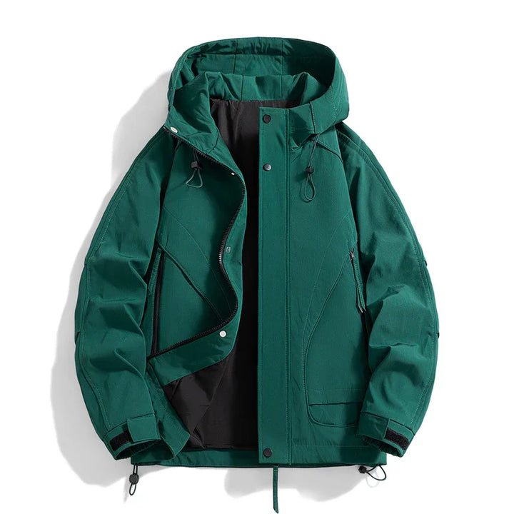 Green hooded waterproof jacket with zip and snap button closure, adjustable cuffs, and black lining
