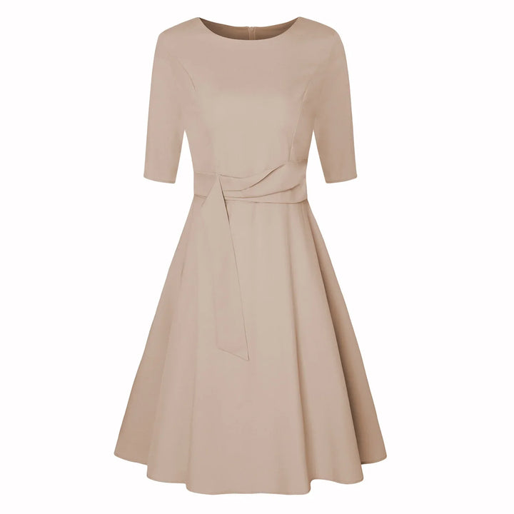 Beige knee-length dress with half sleeves, boat neckline, fitted waist, and flared skirt