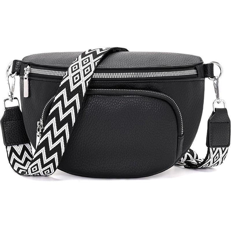 Black leather crossbody bag with silver zippers and detachable black-and-white patterned strap