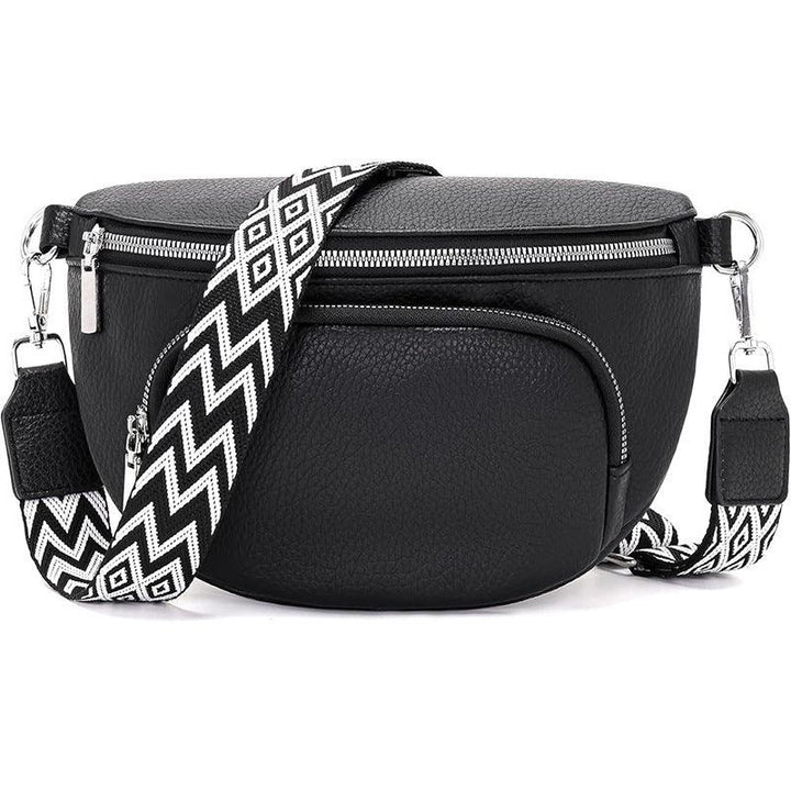 Black leather crossbody bag with silver zippers and detachable black-and-white patterned strap