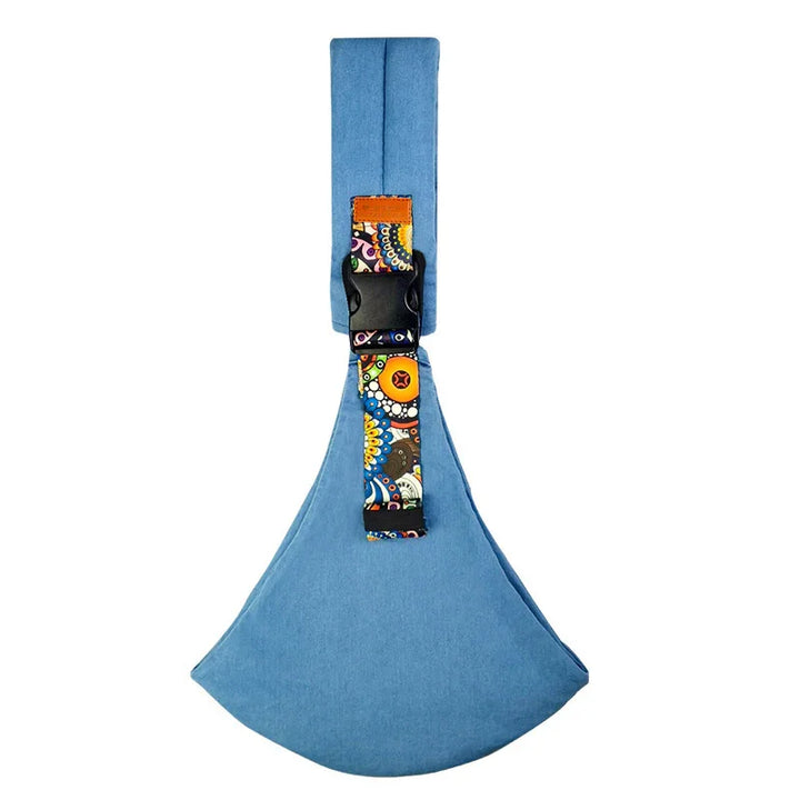 Blue fabric sling bag with colorful floral strap and black buckle on white background