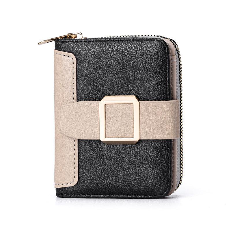 Black and beige leather wallet with gold buckle and zip closure on white background