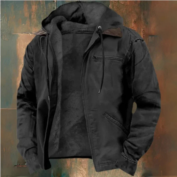 Black men's casual jacket with hood, zippered chest pocket, and side pockets on rustic background
