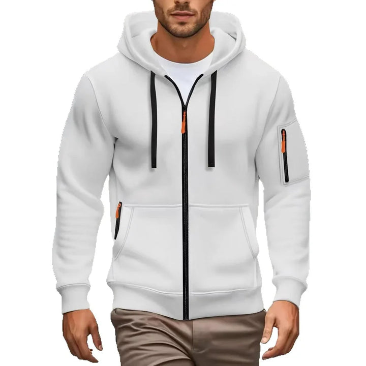Man wearing white zip-up hoodie with black zippers and orange pulls, paired with brown pants