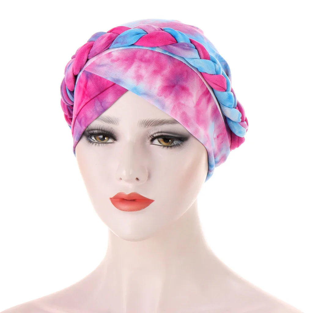 Mannequin head wearing pink and blue tie-dye braided turban headwrap