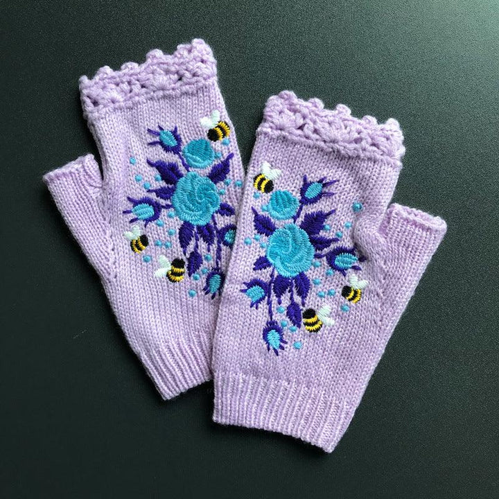 Lavender knitted fingerless gloves with teal blue floral embroidery and small yellow bee designs