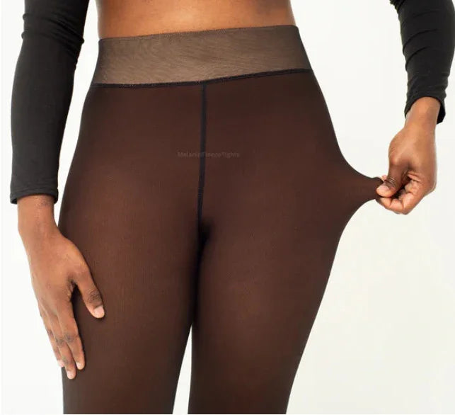 close-up of person wearing sheer black tights, demonstrating stretch with hand pulling fabric at hip