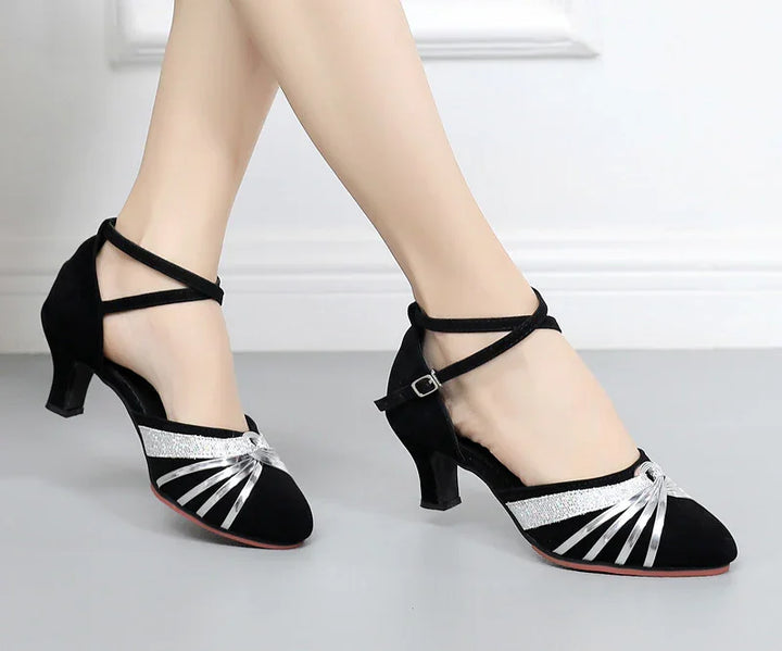 Black suede women's dance shoes with silver straps and mid heels on white background