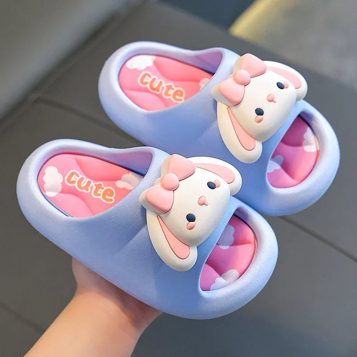 Light purple kids slippers with cartoon bunny faces and pink cushioned insoles with cloud patterns