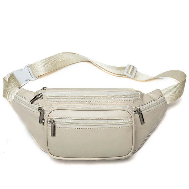 Beige leather waist bag with multiple zippered compartments and adjustable strap