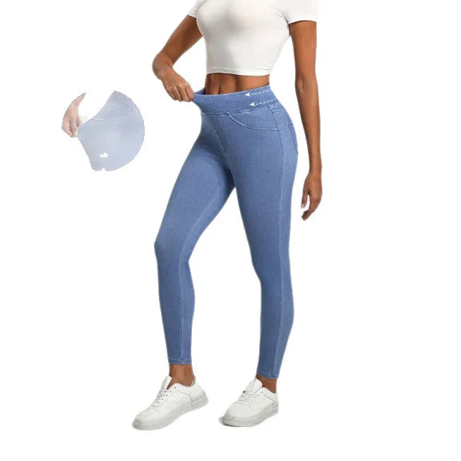 Woman wearing high-waisted blue leggings with stretchy waistband, paired with white crop top and sneakers