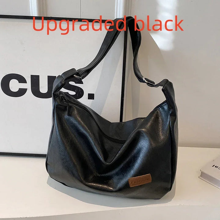 Upgraded black leather shoulder bag with adjustable strap and brown fashion patch