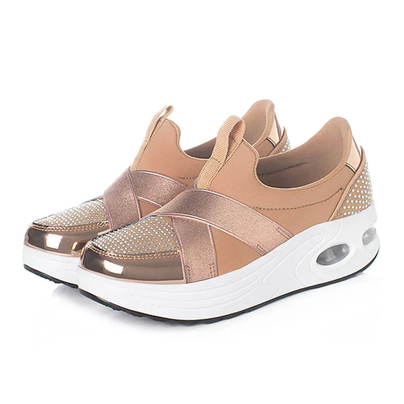Rose gold slip-on platform sneakers with metallic accents and studded back detail