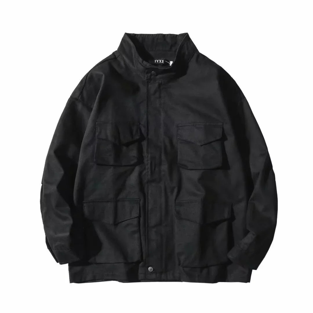 Black utility jacket with four flap pockets and a high collar on white background
