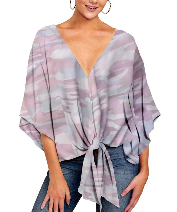 Woman wearing loose fit pink and gray camo print tie-front V-neck blouse with half sleeves