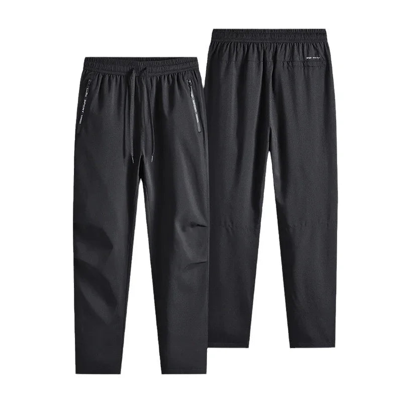 Black men's athletic jogger pants with elastic waistband and zip pockets, front and back view