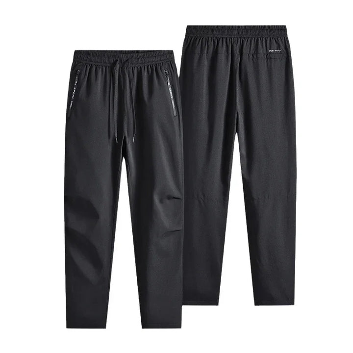 Black men's athletic jogger pants with elastic waistband and zip pockets, front and back view