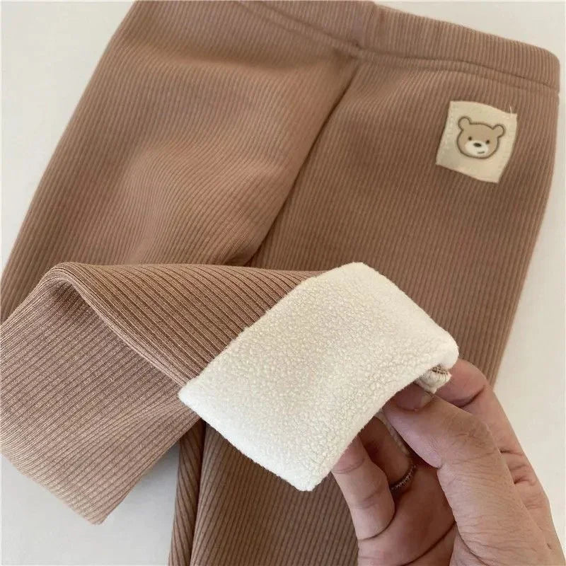 Brown ribbed baby leggings with soft white fleece lining and bear face patch detail