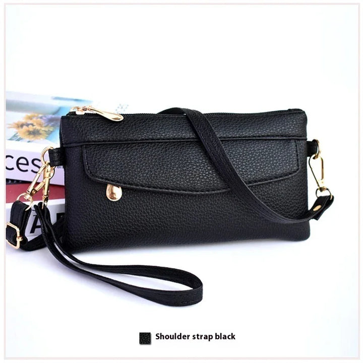 Black pebbled leather clutch purse with detachable shoulder strap and gold hardware