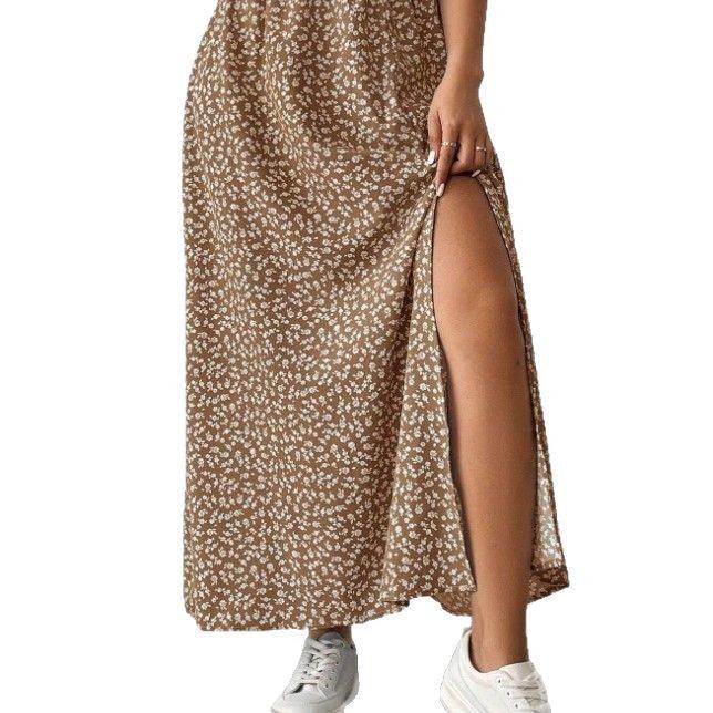 Brown floral maxi skirt with high slit worn with white sneakers on model