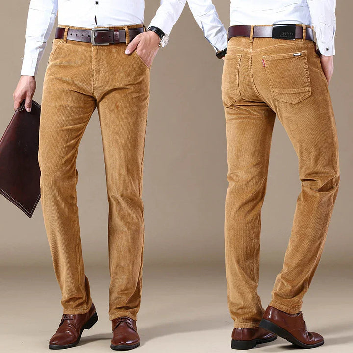 Men's slim fit tan corduroy pants with brown leather belts and brown dress shoes, front and back views