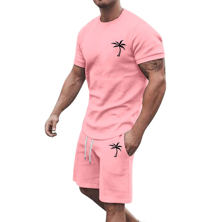 Muscular man wearing pink matching t-shirt and shorts with black palm tree print