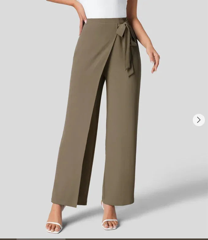Woman wearing high-waist khaki wrap wide-leg pants with a side tie belt and white sandals