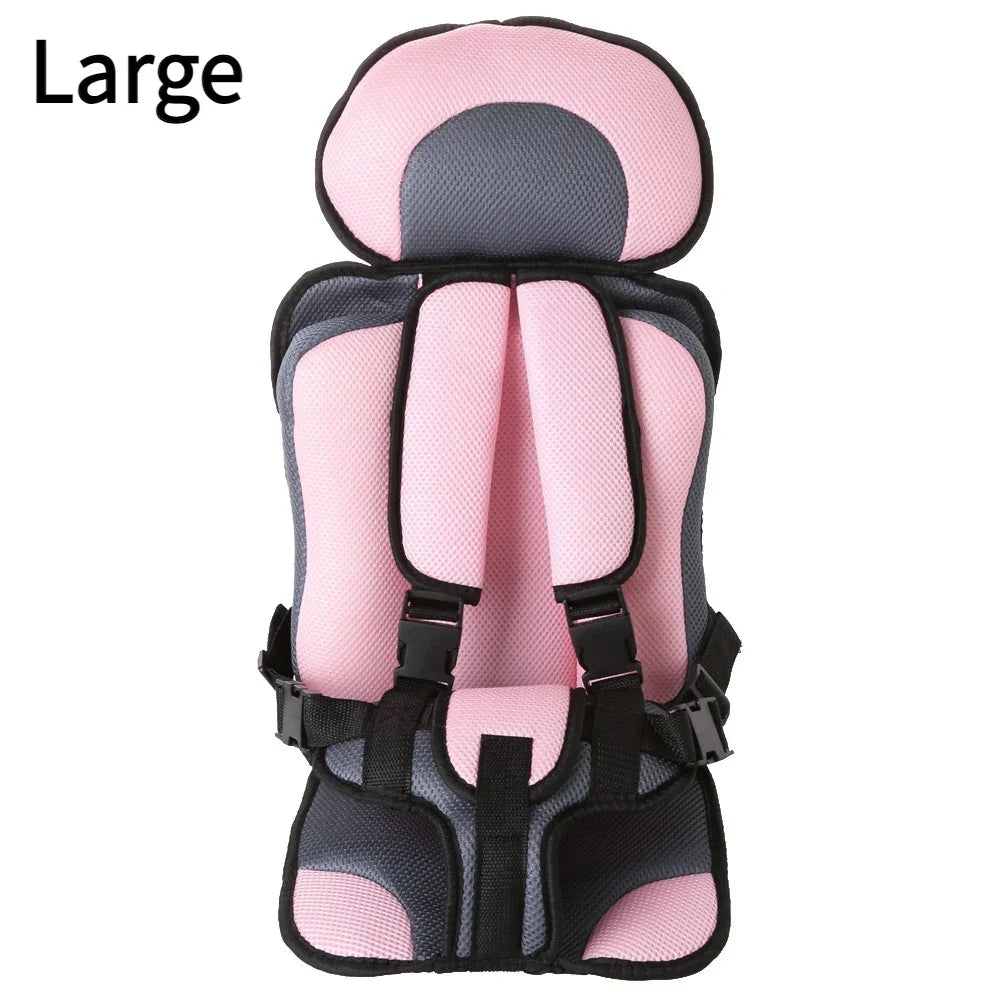 Large pink and gray padded child safety car seat with adjustable straps and headrest