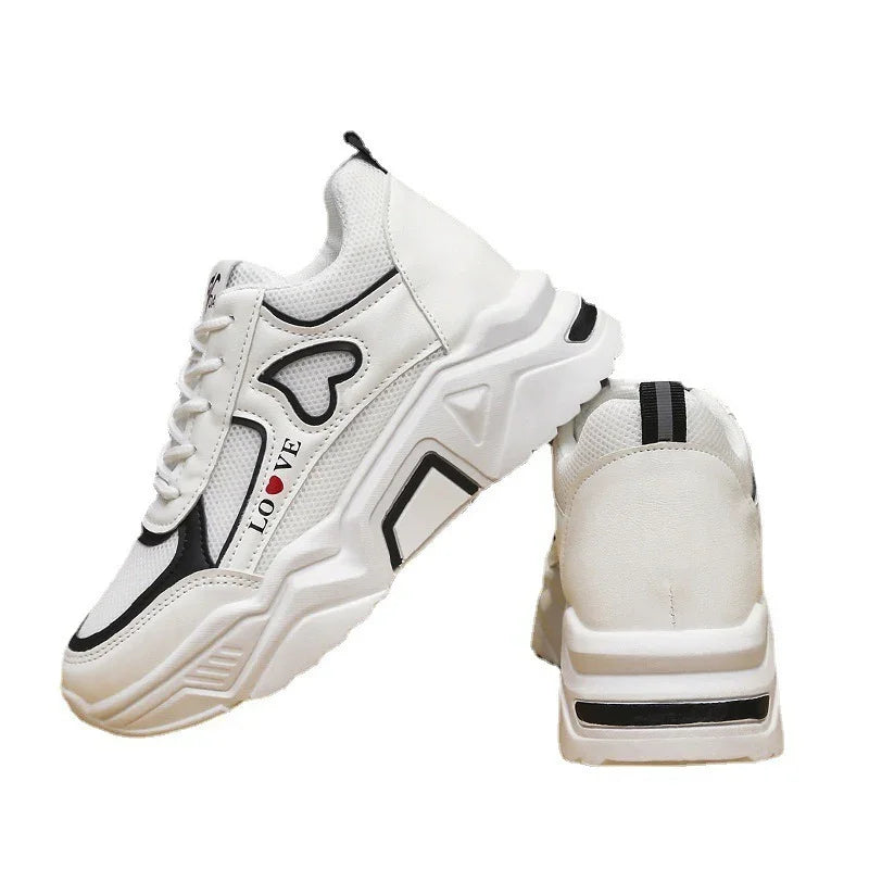 White chunky sneakers with black accents, heart design, and 'LOVE' text on side