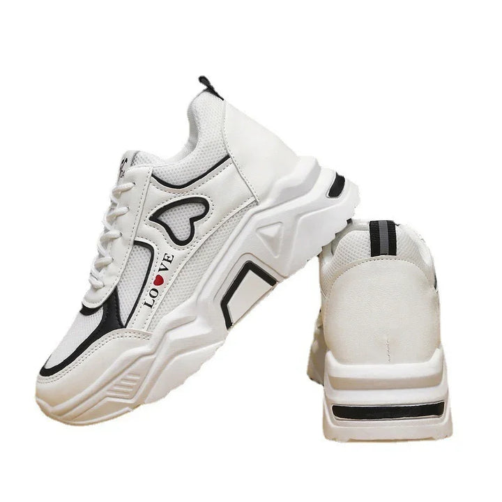 White chunky sneakers with black accents, heart design, and 'LOVE' text on side