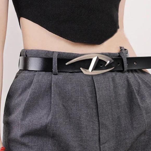 Black leather belt with modern silver buckle on gray high-waisted pleated pants and black cropped top