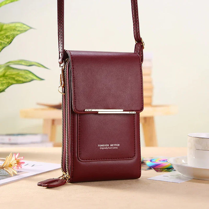 Burgundy leather crossbody phone bag with gold zipper and text 'Forever Better' on front pocket