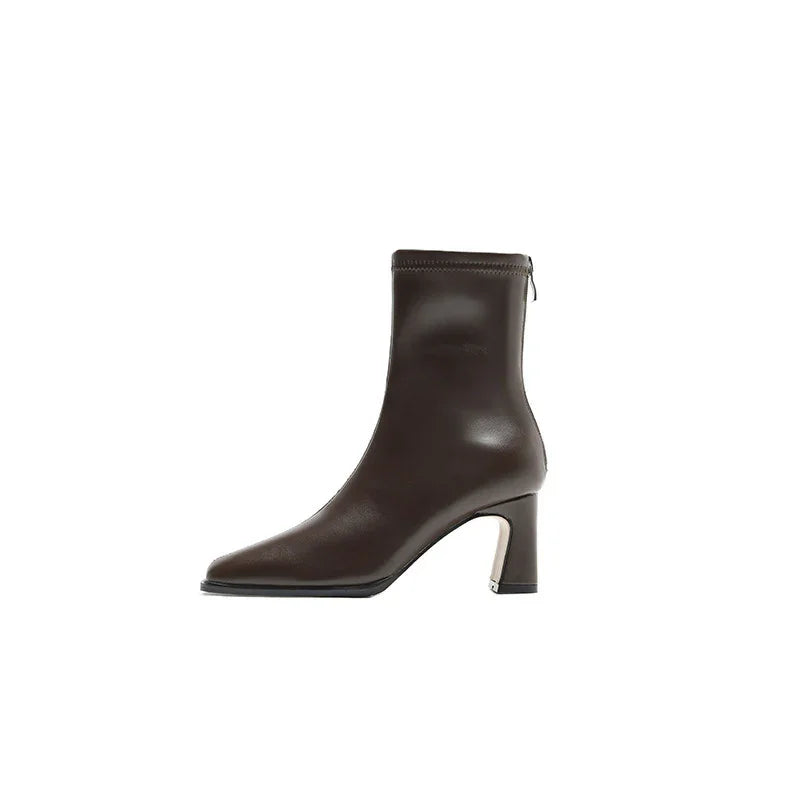 Brown leather ankle boot with block heel and side zipper on white background