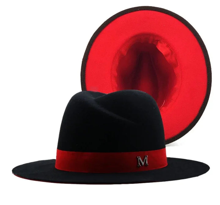 Elegant black fedora hat with red band and red interior lining, featuring metallic 'M' emblem