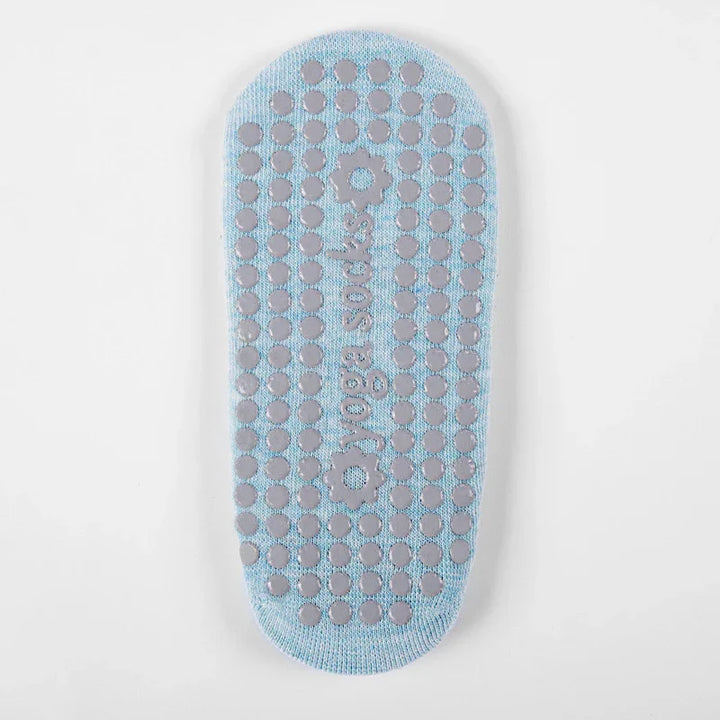 Light blue yoga socks with non-slip gray grip dots and floral grip patterns on sole
