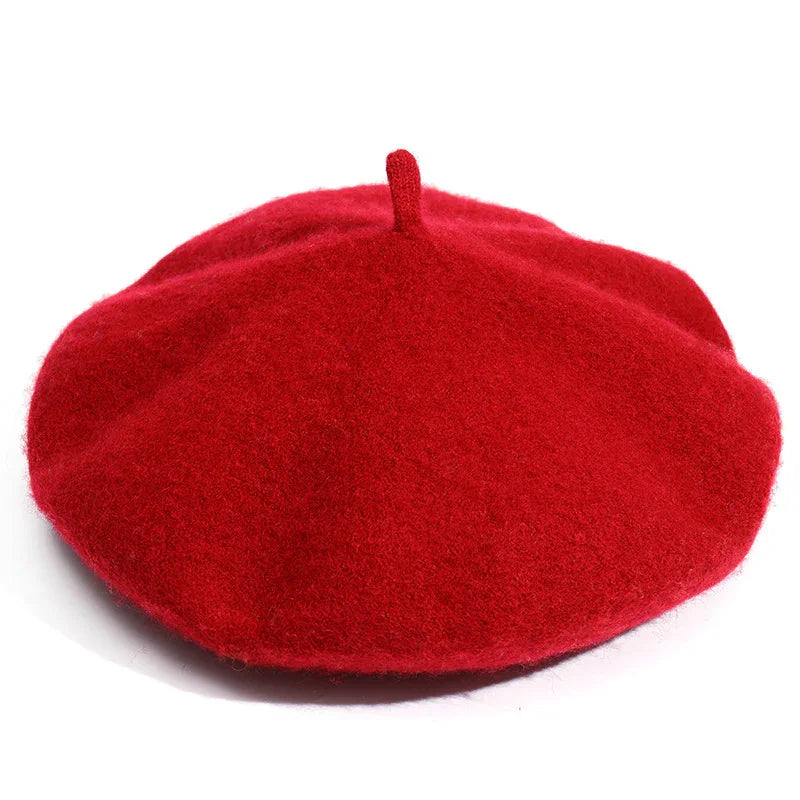 Classic red wool beret hat with top stem on white background