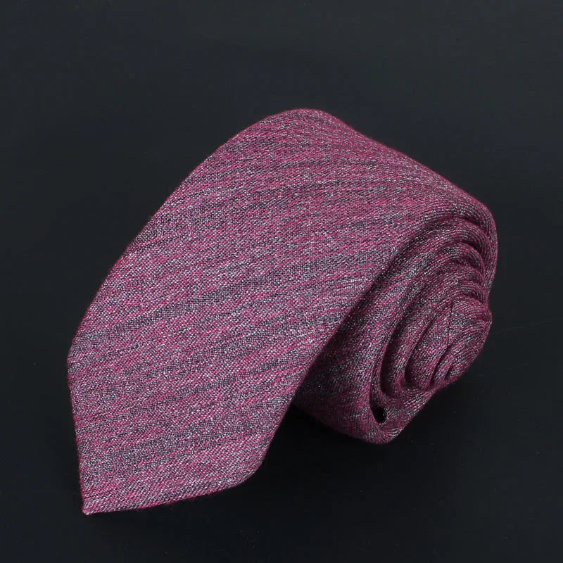 Rolled textured purple knit necktie on black background