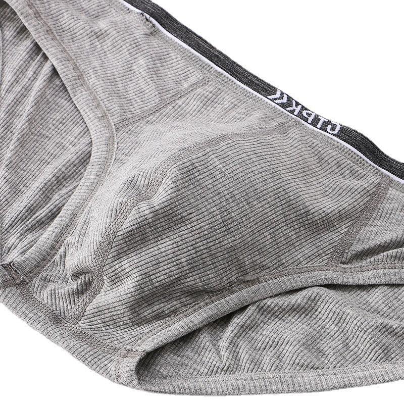 Close-up of gray ribbed fabric men's briefs with black elastic waistband and white logo